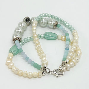 Fresh water pearls accompany minty green and palest blue glass beads on a triple strung bracelet and matching dangle earrings.