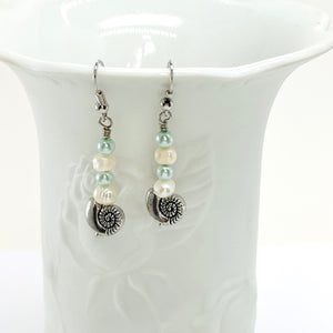 Fresh water pearls accompany minty green and palest blue glass beads on a triple strung bracelet and matching dangle earrings.