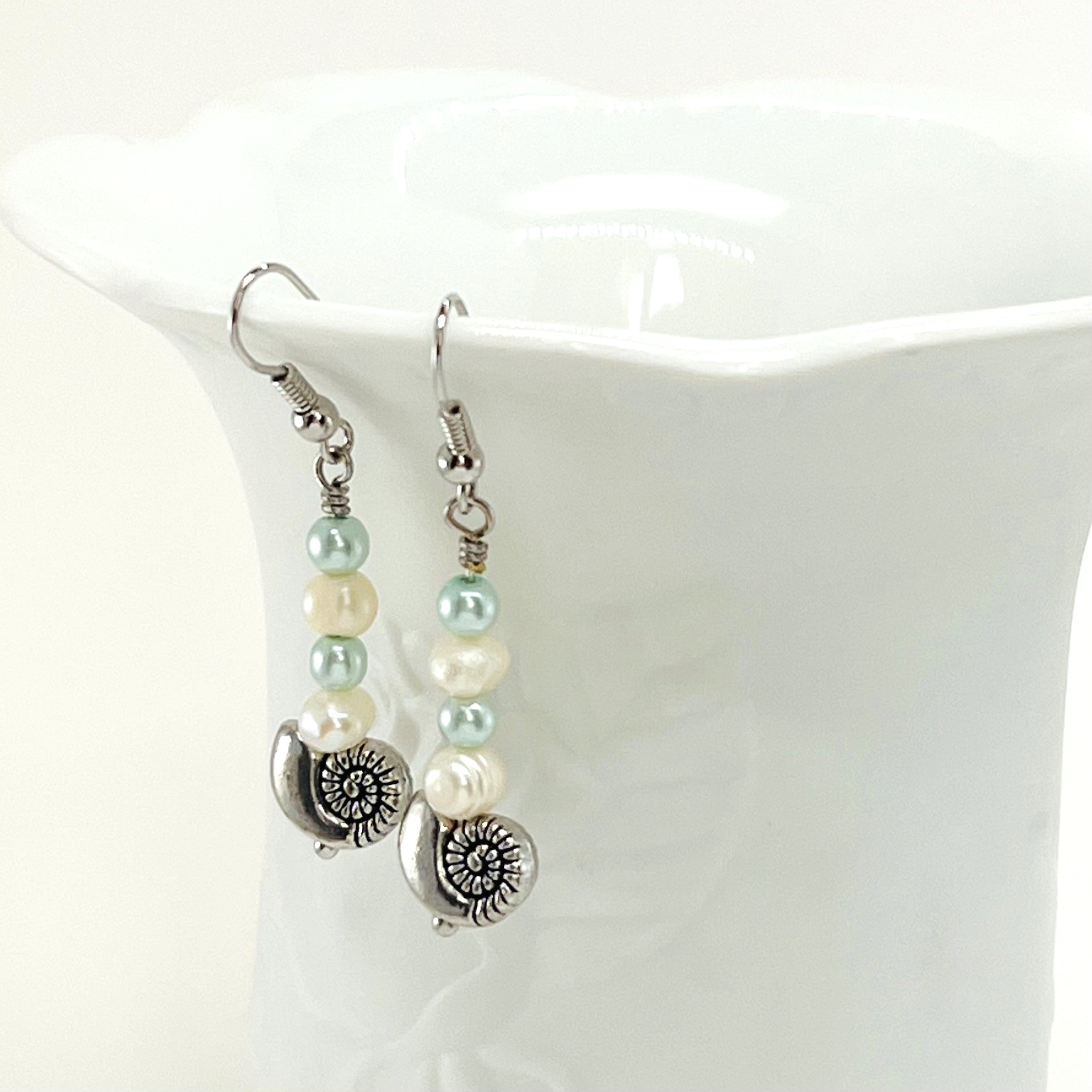 Fresh water pearls accompany minty green and palest blue glass beads on a triple strung bracelet and matching dangle earrings.