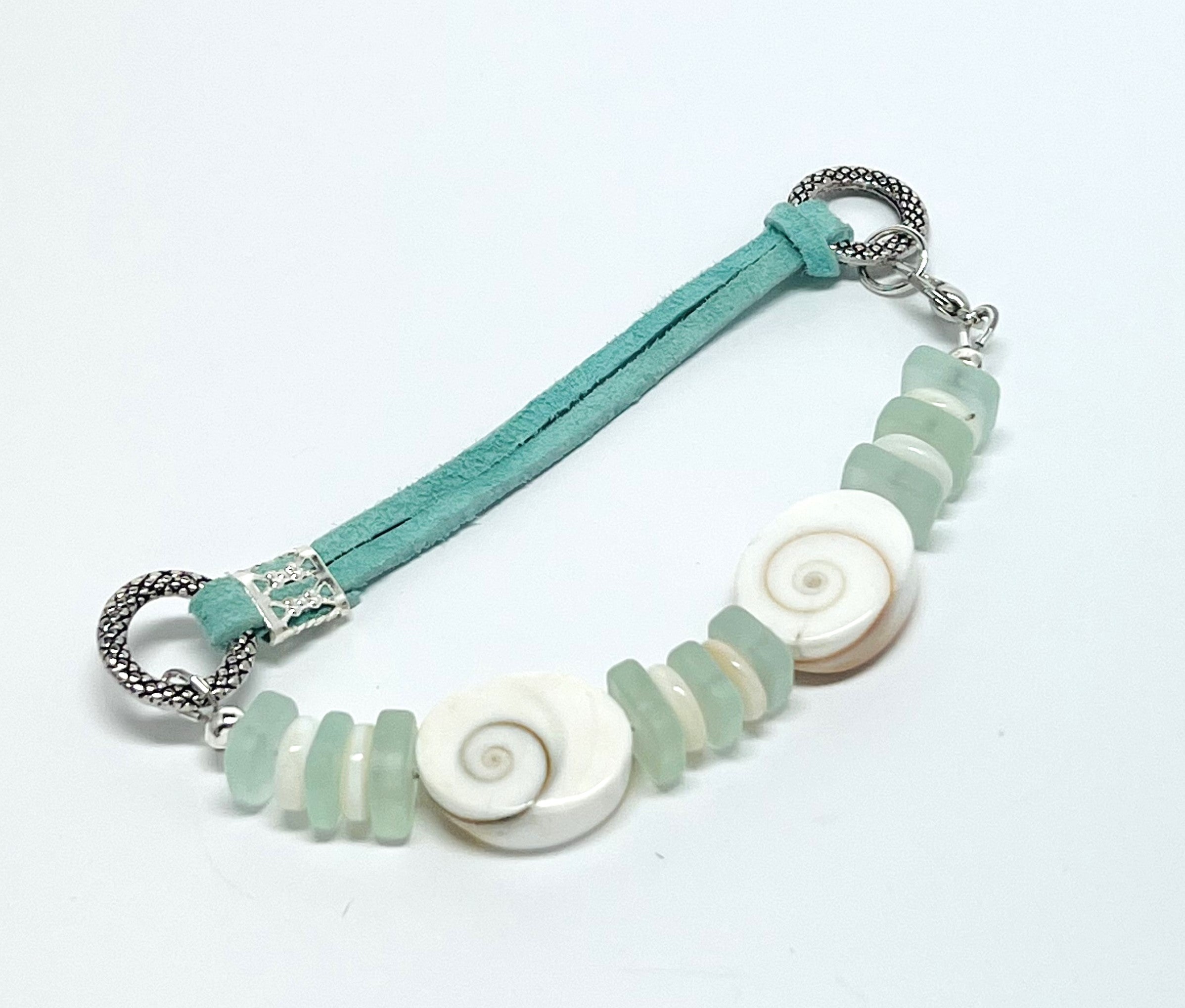 Simple and classic sea shell, leather, and frosted sea glass beads in mint green