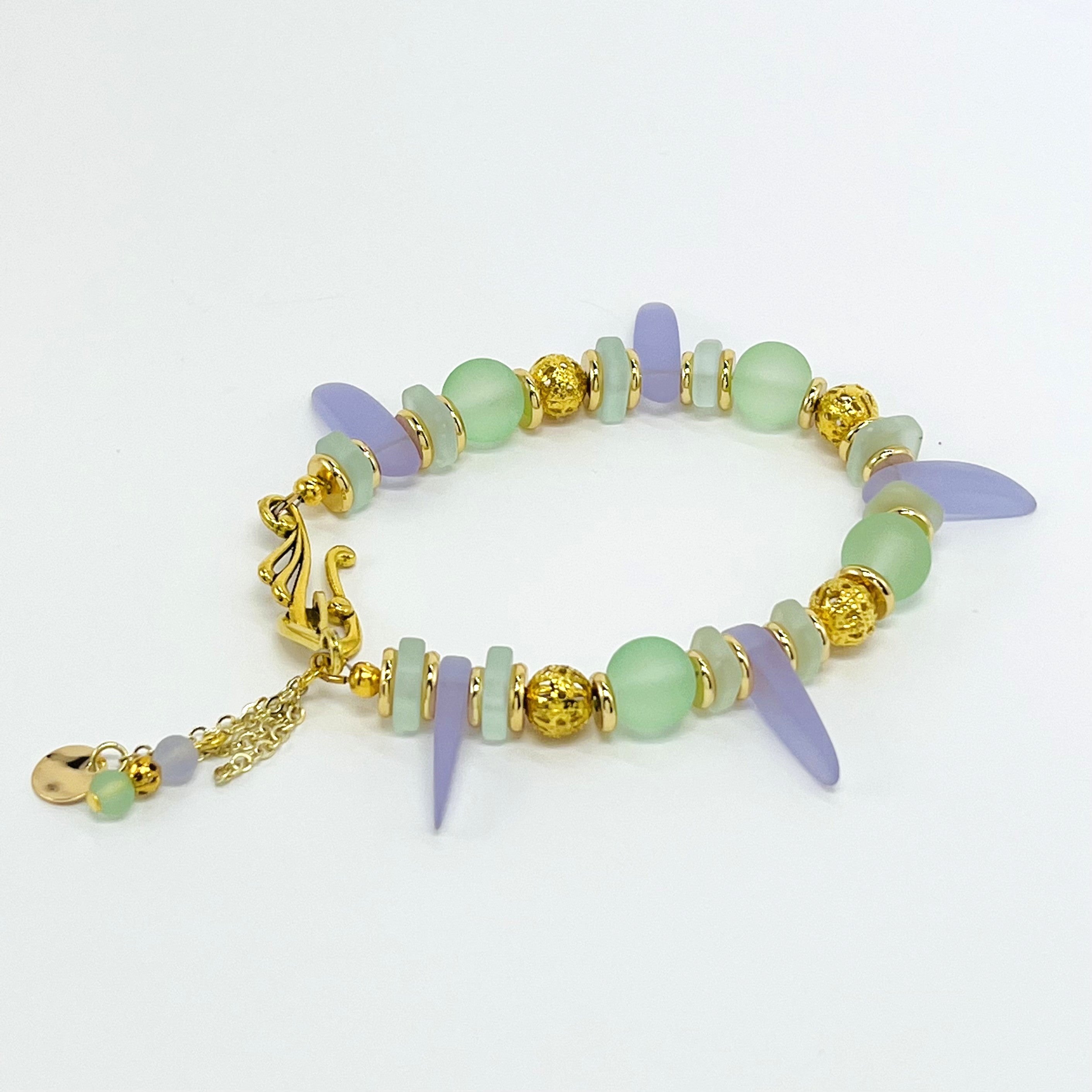 Sensitive lilac and mint green sea glass beads complimented with gold plated accents bracelet and earring set