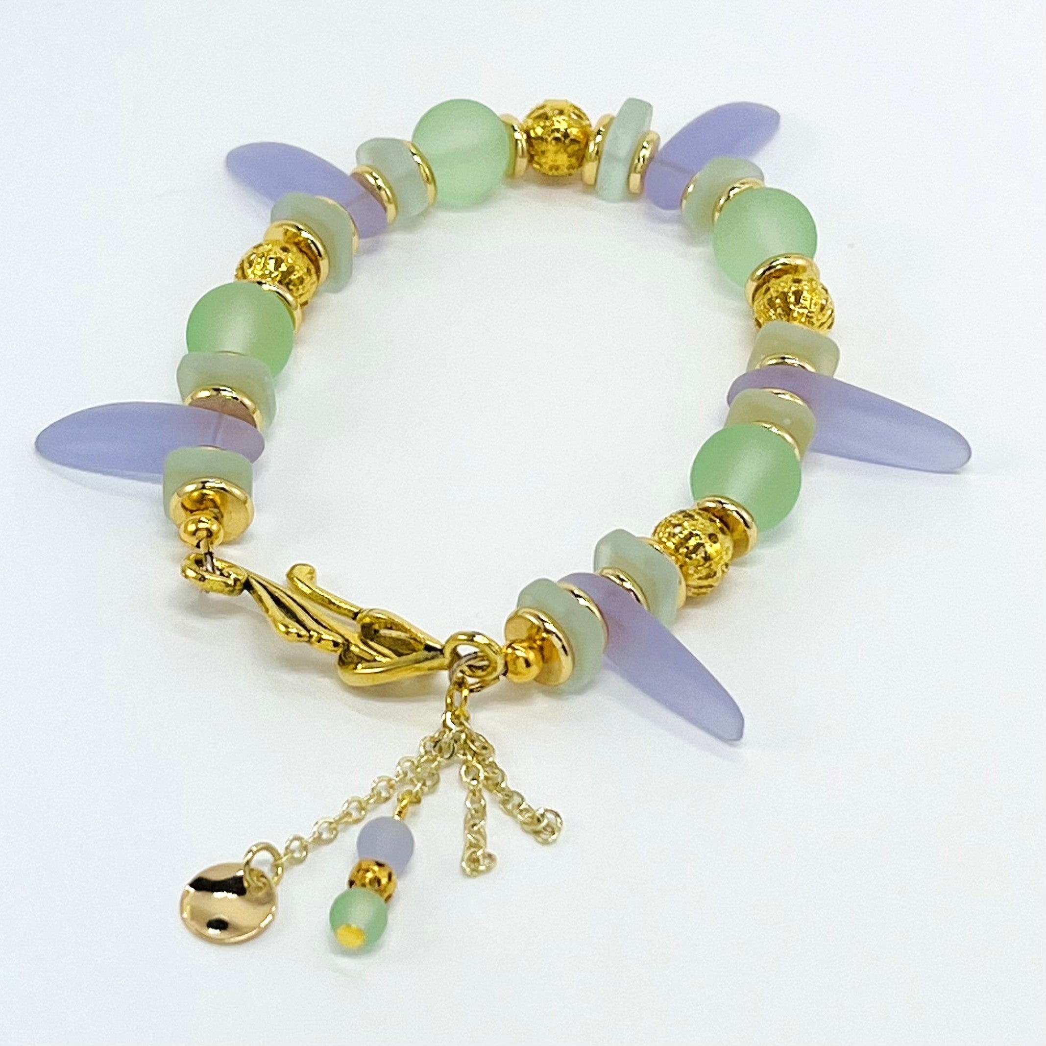 Sensitive lilac and mint green sea glass beads complimented with gold plated accents bracelet and earring set