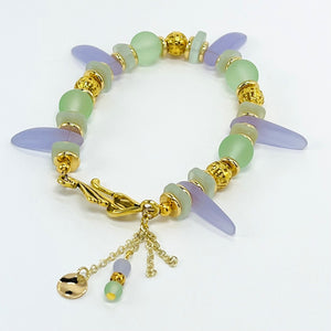 Sensitive lilac and mint green sea glass beads complimented with gold plated accents bracelet and earring set