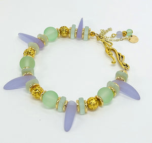 Sensitive lilac and mint green sea glass beads complimented with gold plated accents bracelet and earring set