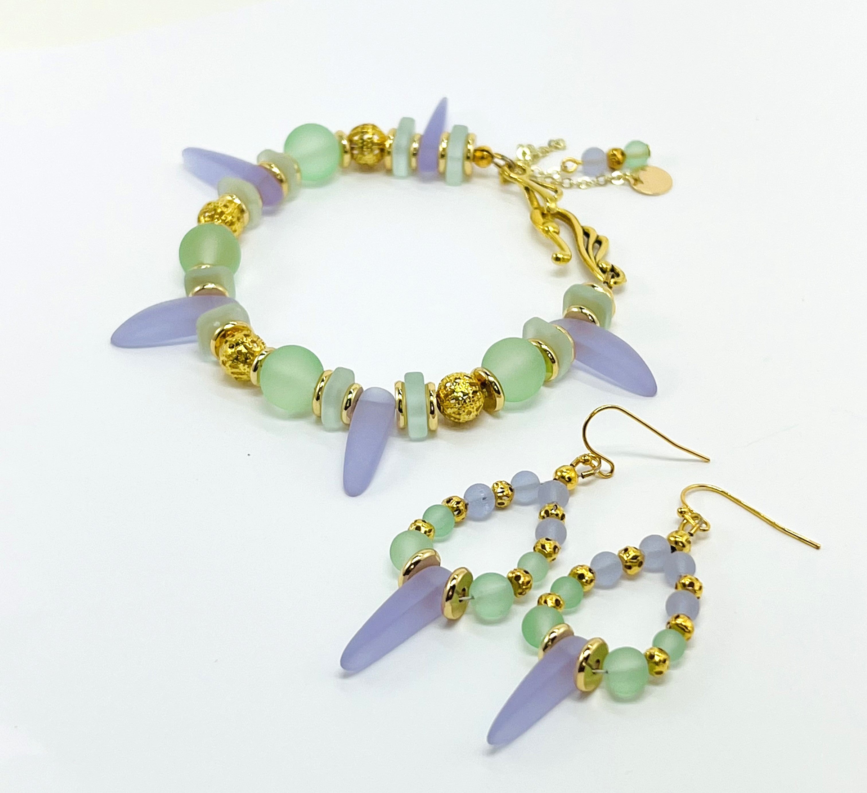 Sensitive lilac and mint green sea glass beads complimented with gold plated accents bracelet and earring set