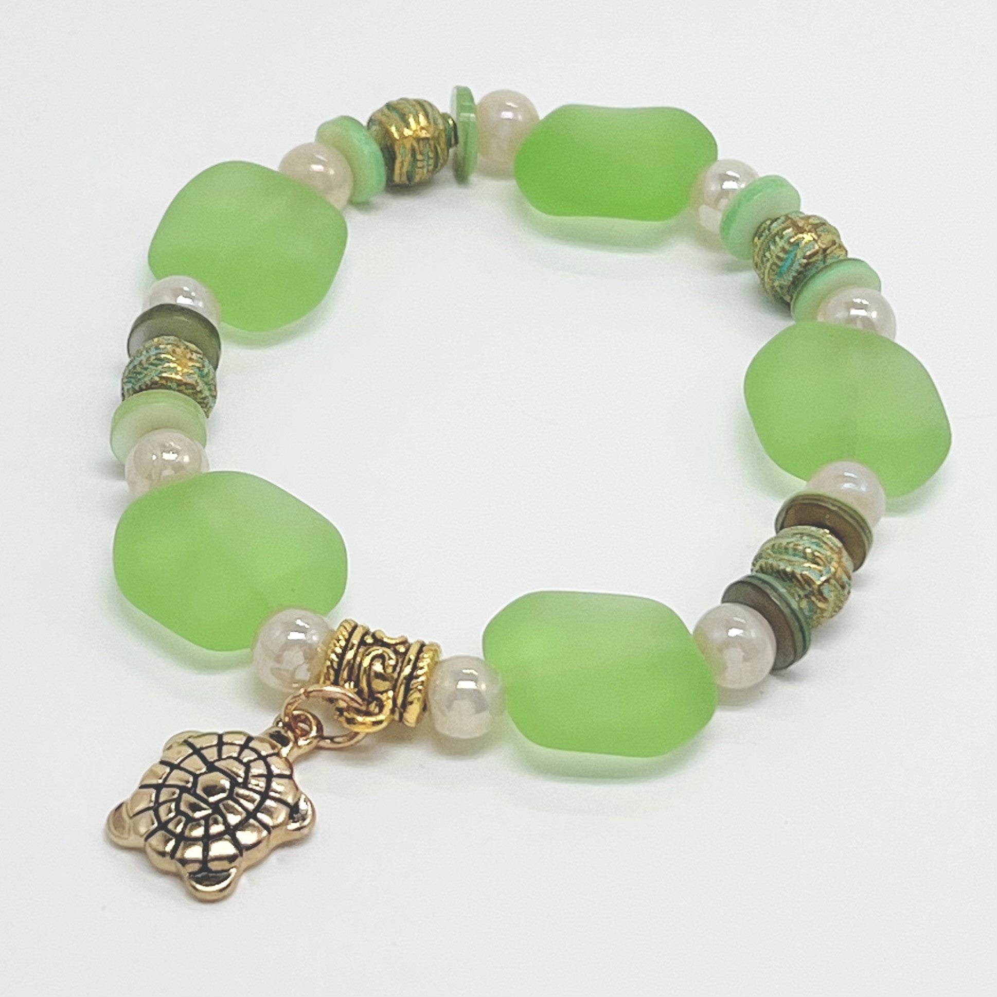 Ocean green sea glass look with glass, shell and gold plated metal accents and turtle charm bracelet and earring set