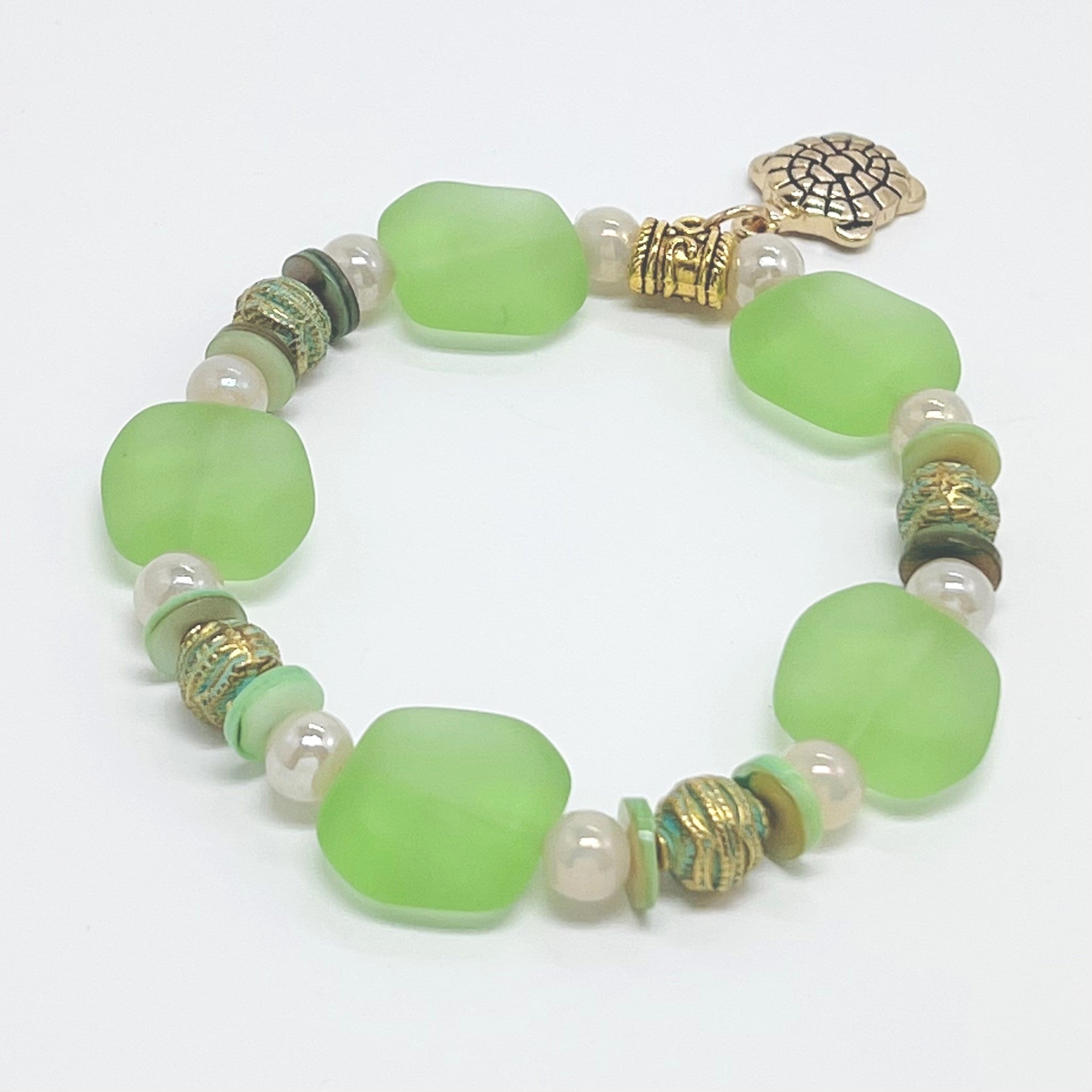 Ocean green sea glass look with glass, shell and gold plated metal accents and turtle charm bracelet and earring set