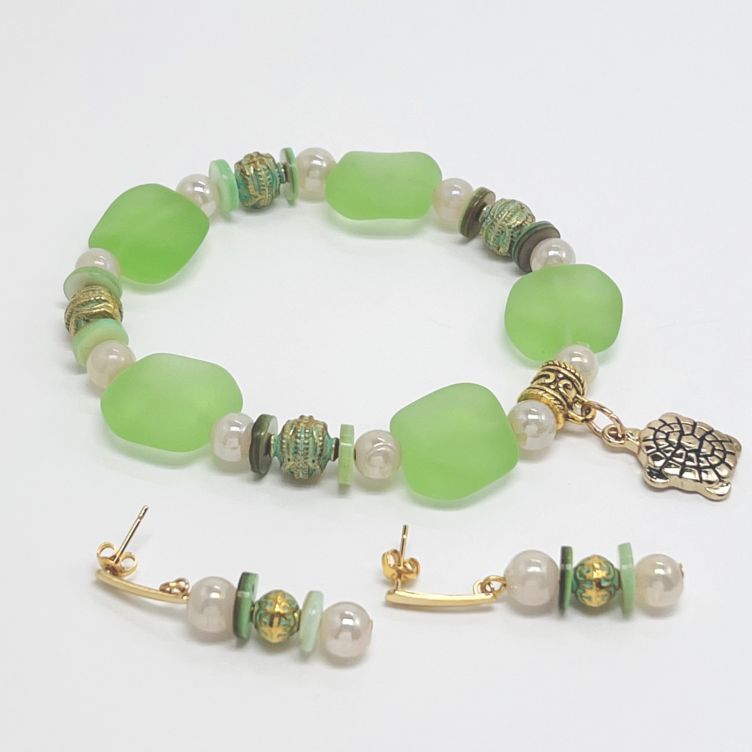 Ocean green sea glass look with glass, shell and gold plated metal accents and turtle charm bracelet and earring set