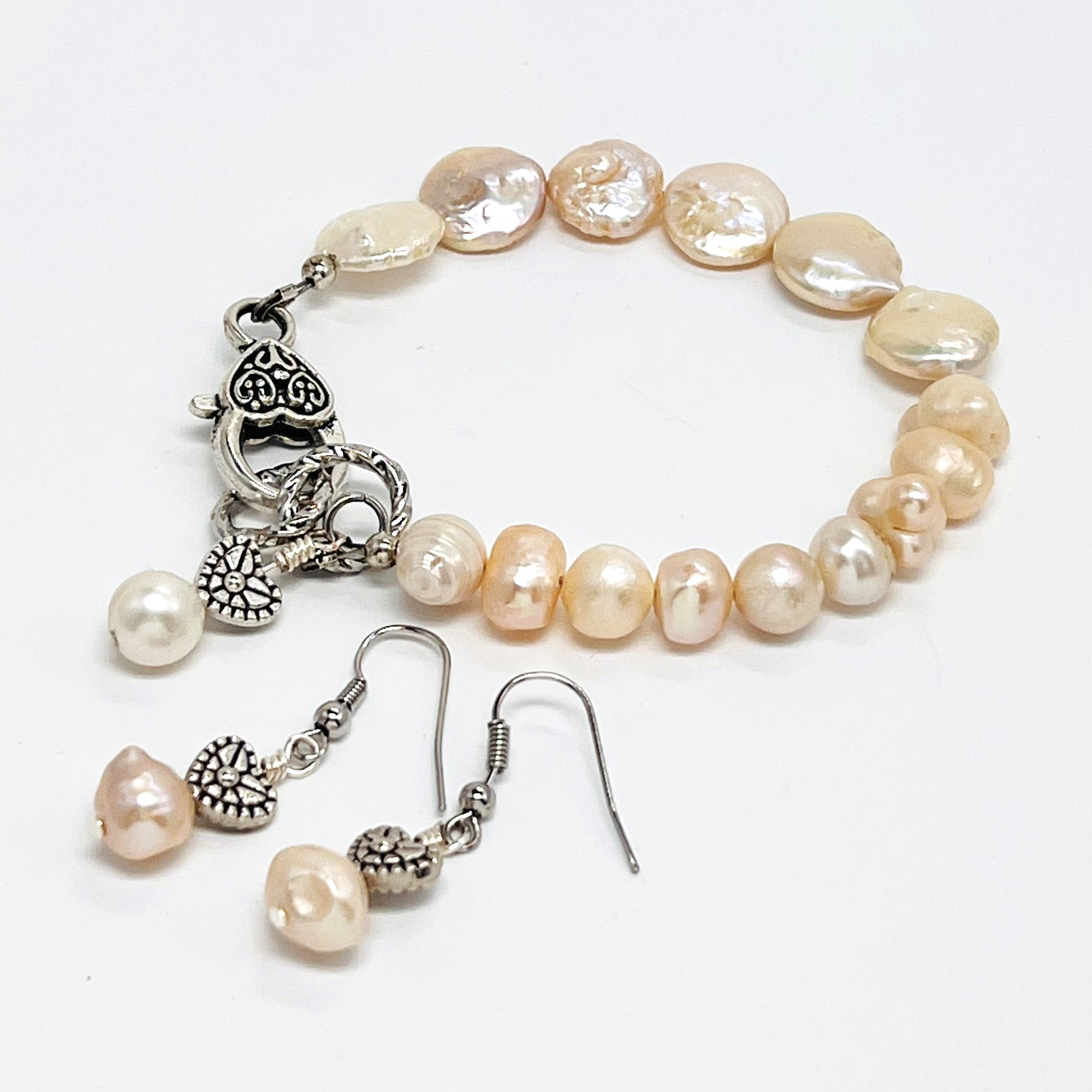 Lovely creamy color freshwater pearls and coin shaped pearls with silver plated accents