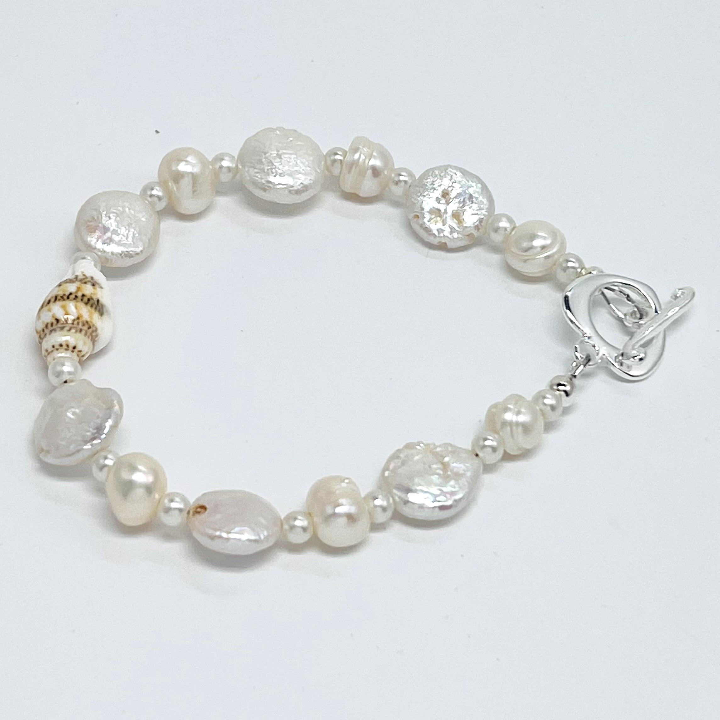 Creamy white fresh water pearls, coin pearls and natural sea shell