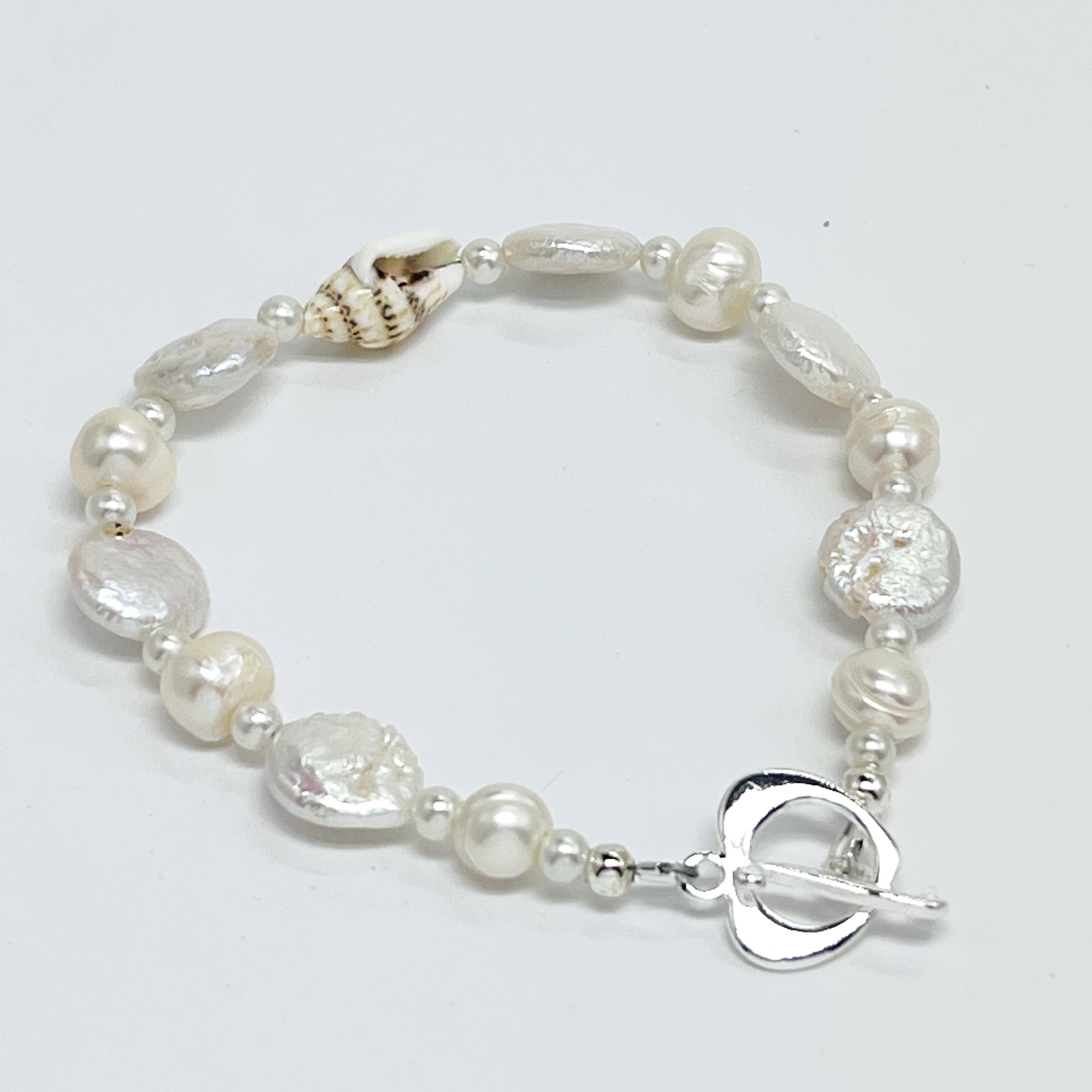 Creamy white fresh water pearls, coin pearls and natural sea shell