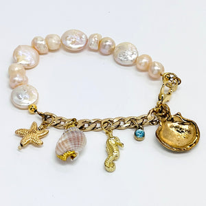 Sophisticated charm bracelet with fresh water and coin pearls and assorted gold plated chain and sea life charms