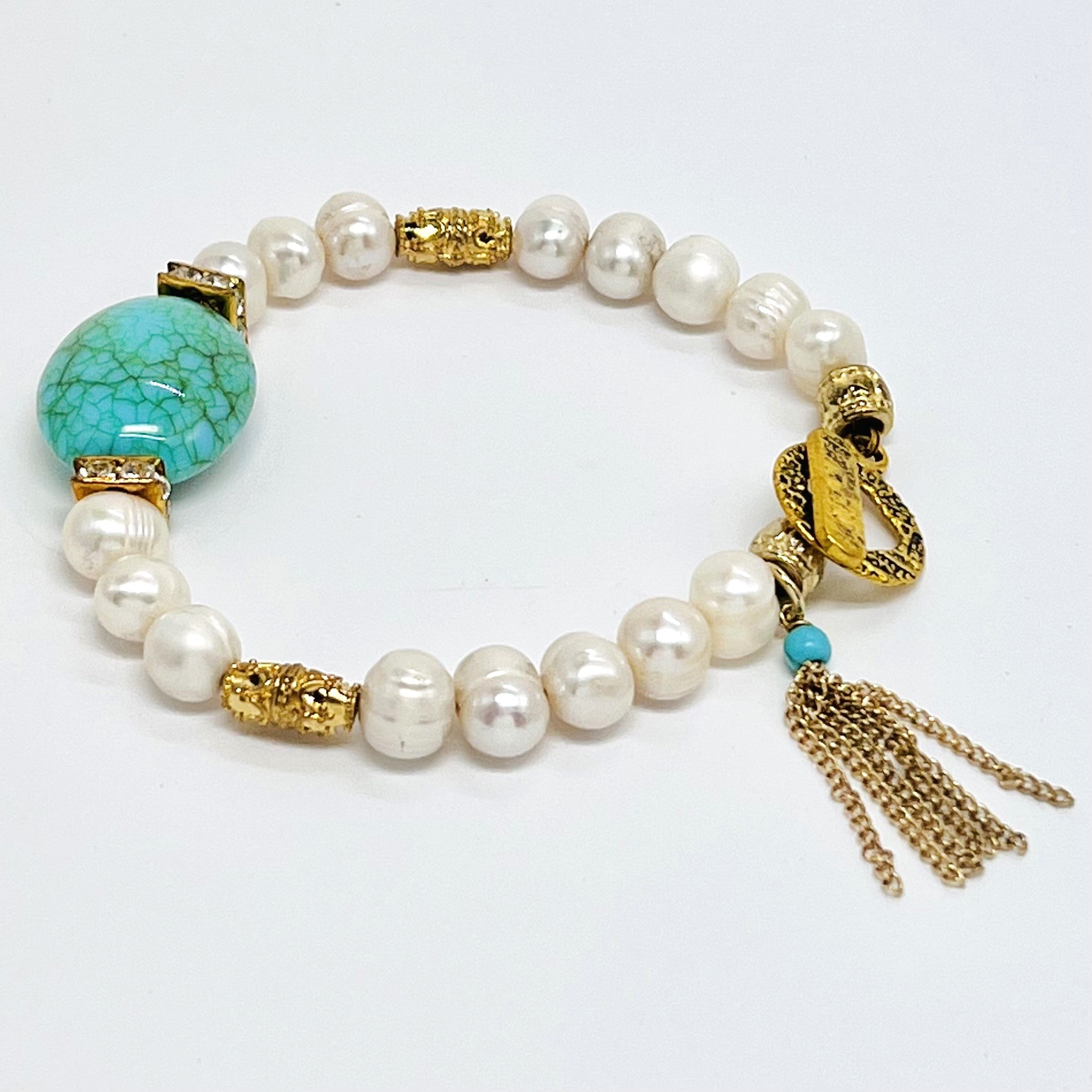 Fresh water pearl beaded bracelet with gold plated metal elements and an acrylic turquoise focal bead