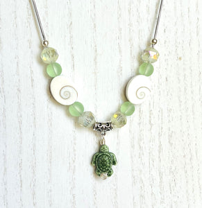 Beachy frosted mint sea glass and spiral shells necklace and earring set with a cute ceramic green turtle dangle