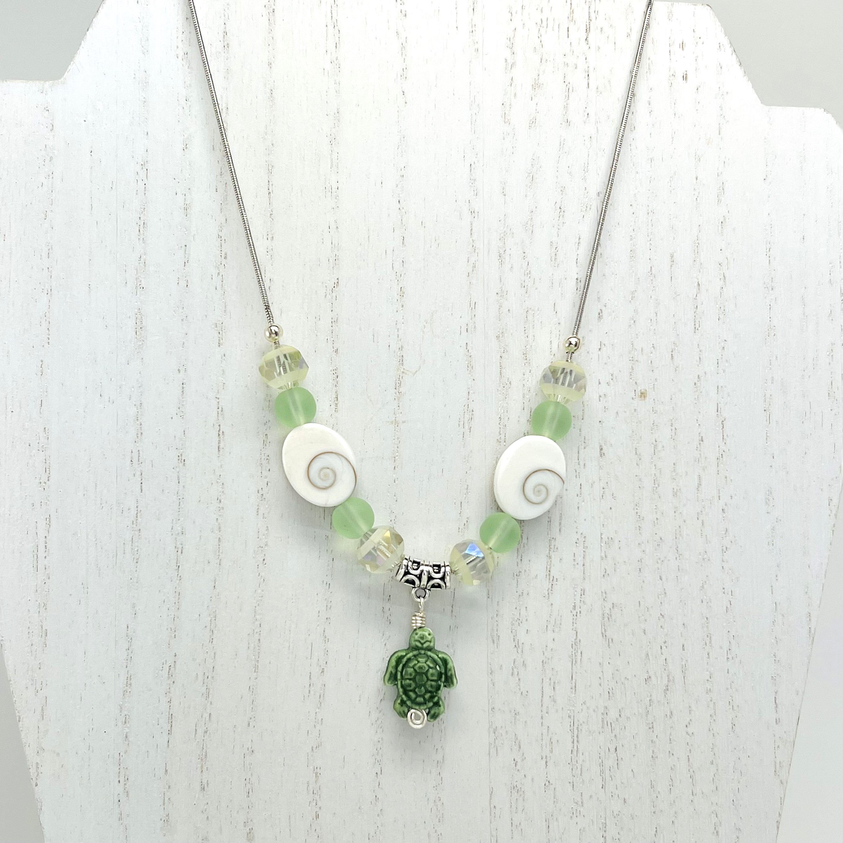 Beachy frosted mint sea glass and spiral shells necklace and earring set with a cute ceramic green turtle dangle