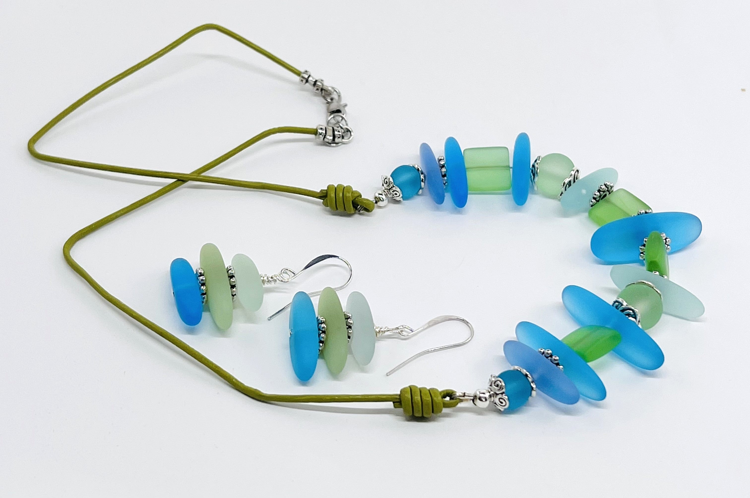 Leather necklace and earring set of frosty sea glass beads in the beautiful blue and green colors of the Caribbean sea