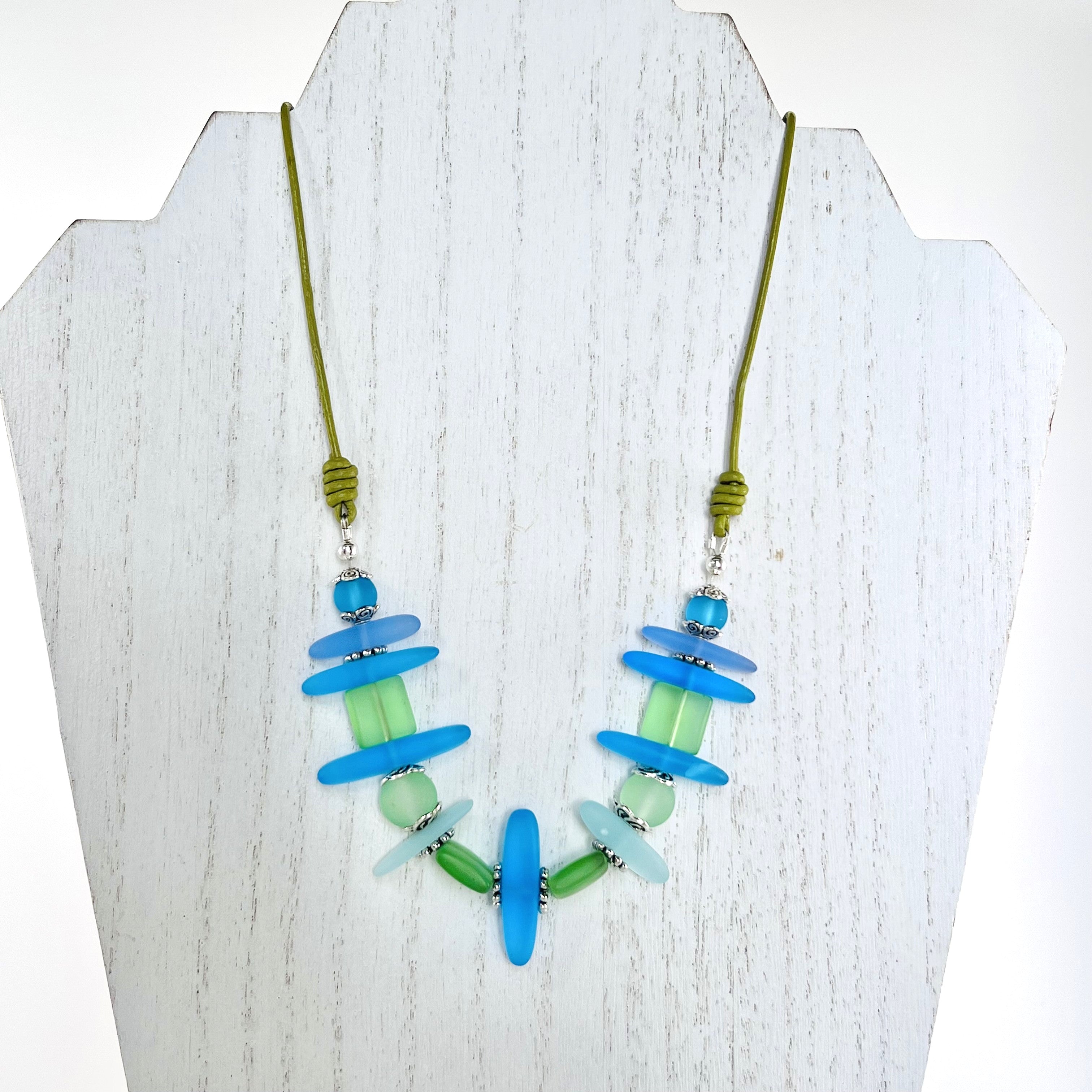 Leather necklace and earring set of frosty sea glass beads in the beautiful blue and green colors of the Caribbean sea