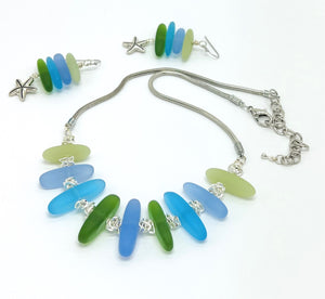 Cool Caribbean sea colors in frosty blue and green sea glass beads hanging on a silver plated snake chain with matching earrings