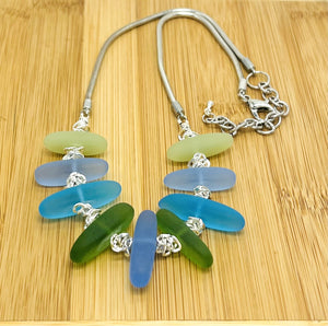 Cool Caribbean sea colors in frosty blue and green sea glass beads hanging on a silver plated snake chain with matching earrings