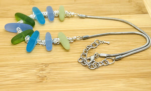 Cool Caribbean sea colors in frosty blue and green sea glass beads hanging on a silver plated snake chain with matching earrings