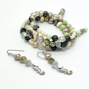 Beachy memory wire bracelet in cool cream, green, purple and lavender beads with silver seahorse accents