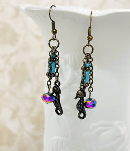 Seahorse earrings with turquoise and rainbow colored glass beads with antique brass ear wires