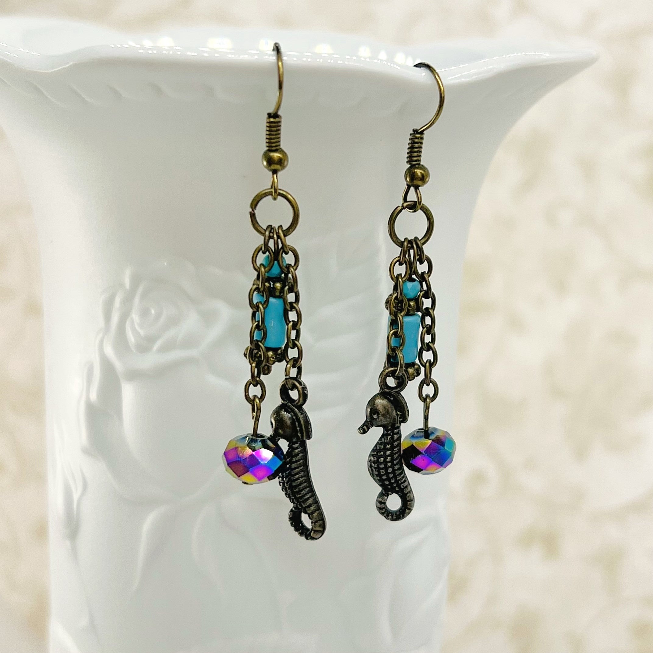 Seahorse earrings with turquoise and rainbow colored glass beads with antique brass ear wires