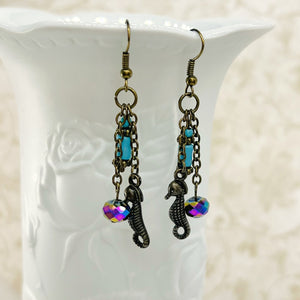 Seahorse earrings with turquoise and rainbow colored glass beads with antique brass ear wires