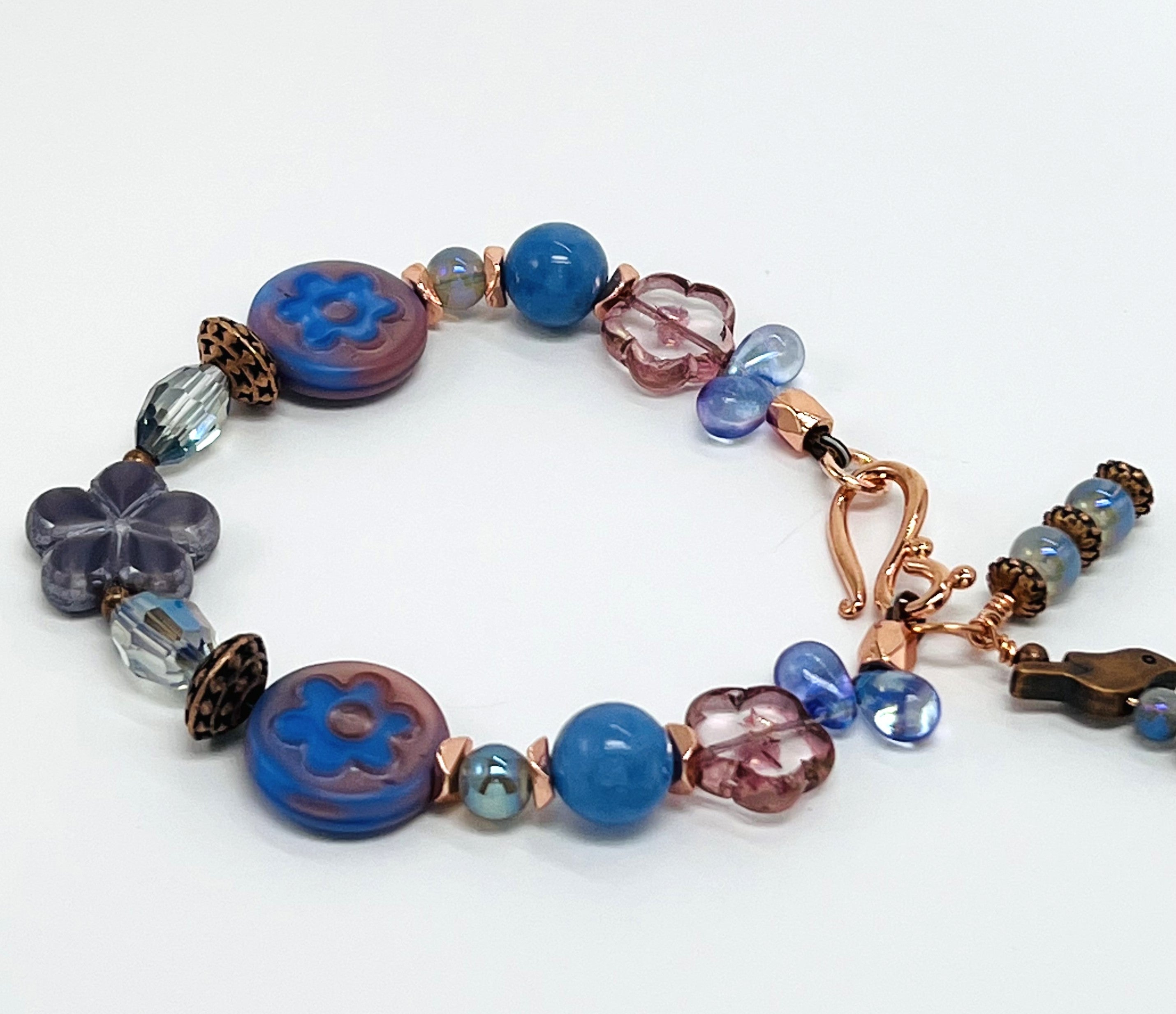 Czech glass bracelet and earring set with blue and peach flower beads, fire agate, copper bird and accents