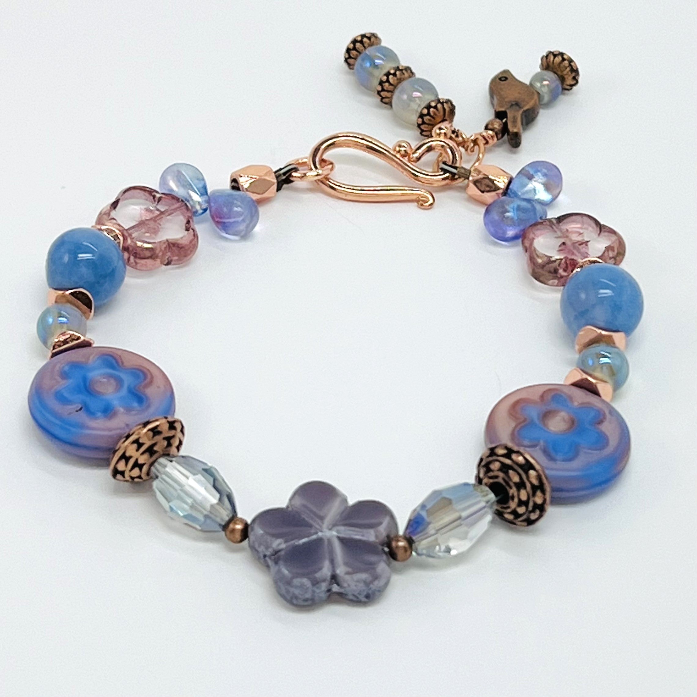 Czech glass bracelet and earring set with blue and peach flower beads, fire agate, copper bird and accents