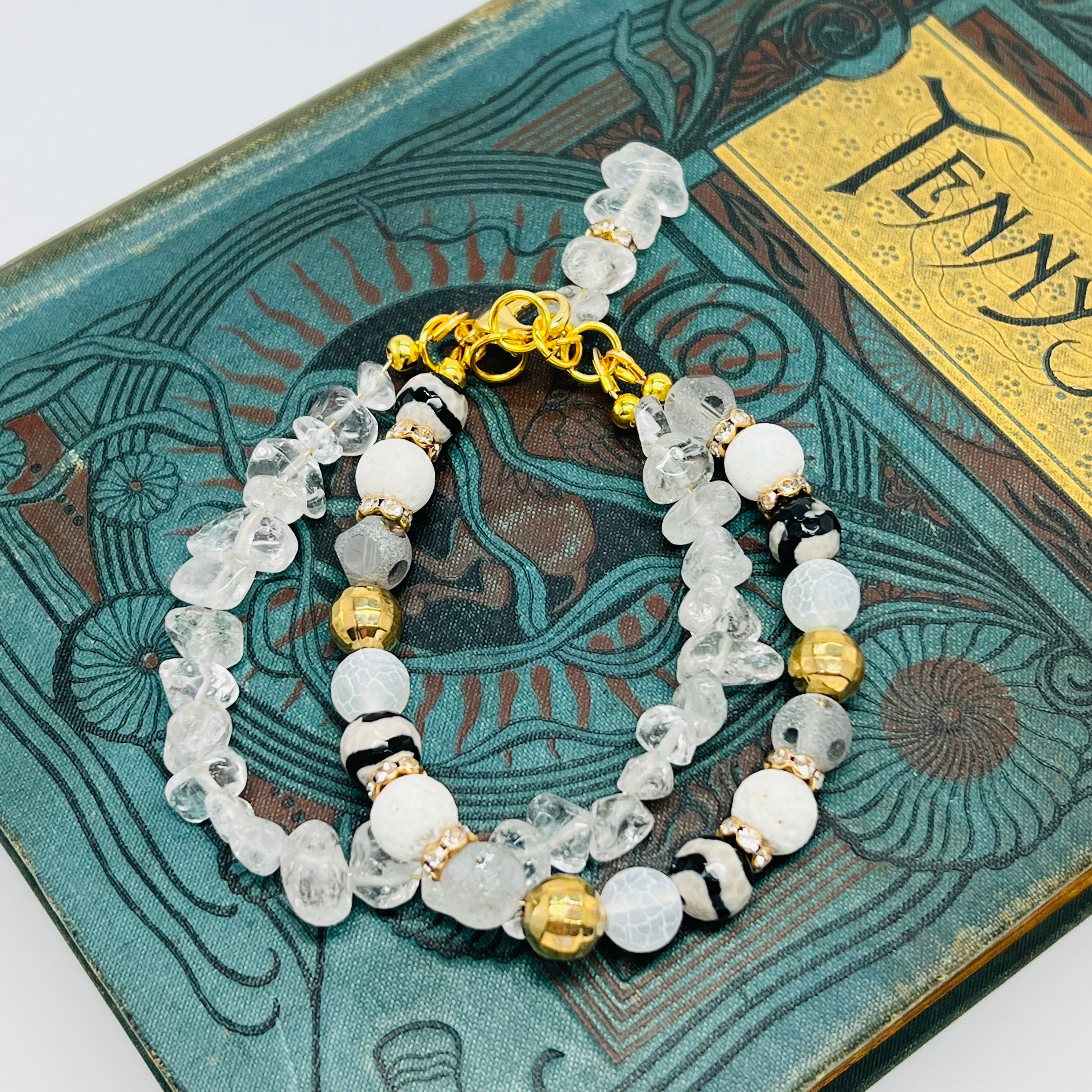 Bracelet and earring set of white quartz chips combined with glass, lava and stone beads accented with gold metals