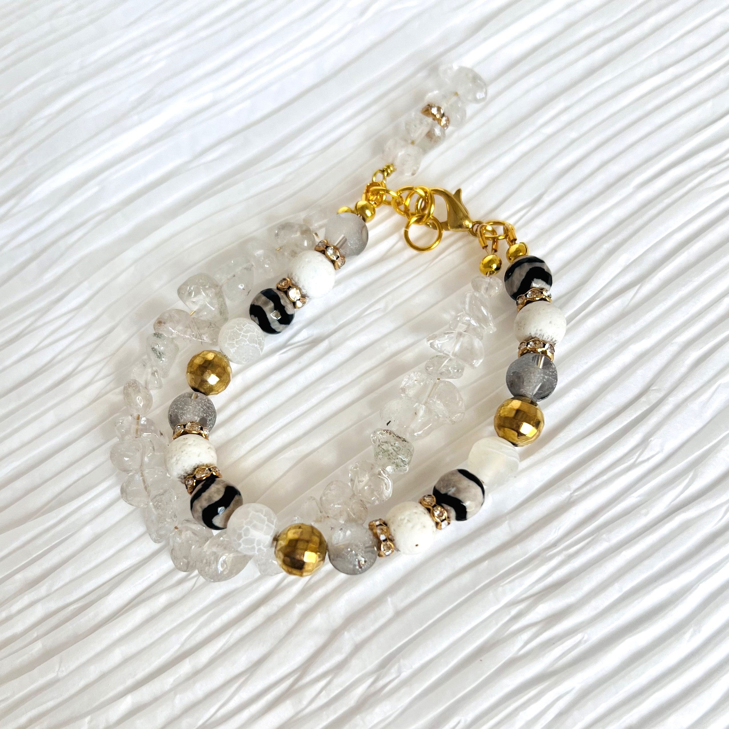 Bracelet and earring set of white quartz chips combined with glass, lava and stone beads accented with gold metals