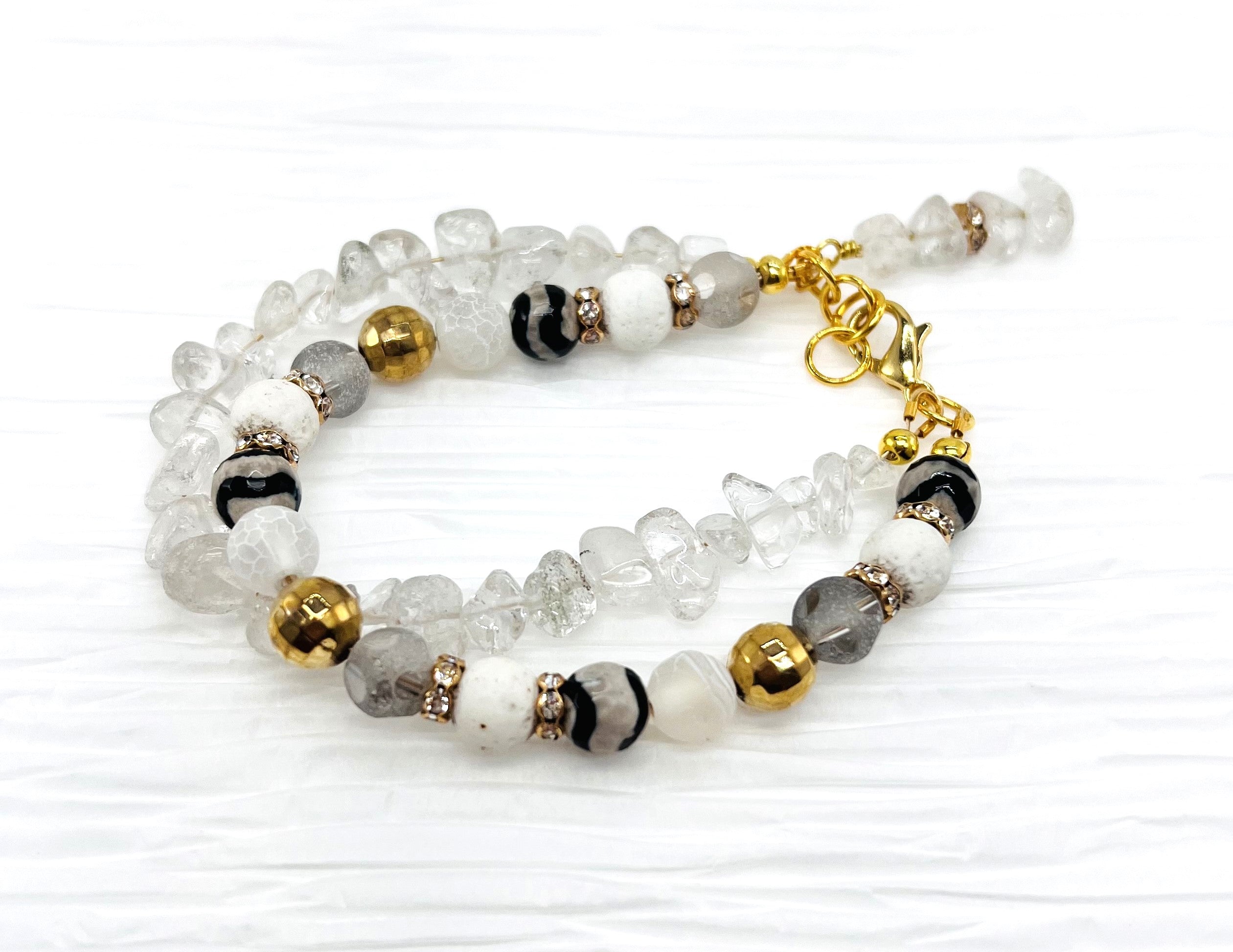 Bracelet and earring set of white quartz chips combined with glass, lava and stone beads accented with gold metals