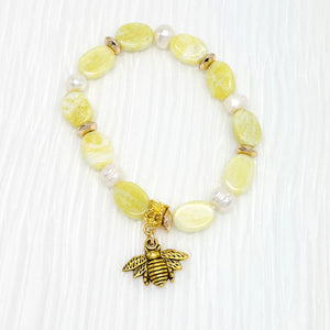 Lovely lemony yellow semiprecious agate stretchy bracelet with pearls and a bee charm with gold hemitite accents