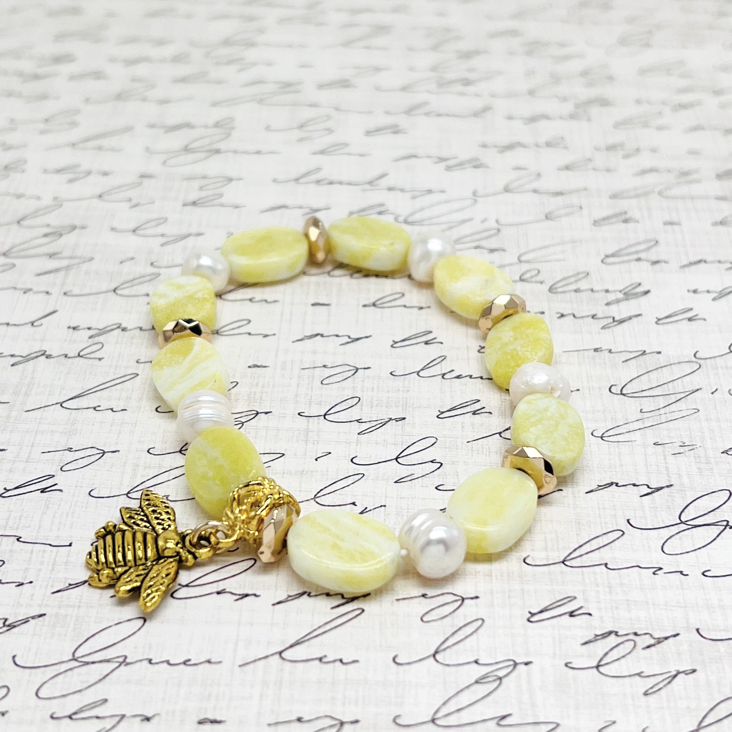 Lovely lemony yellow semiprecious agate stretchy bracelet with pearls and a bee charm with gold hemitite accents