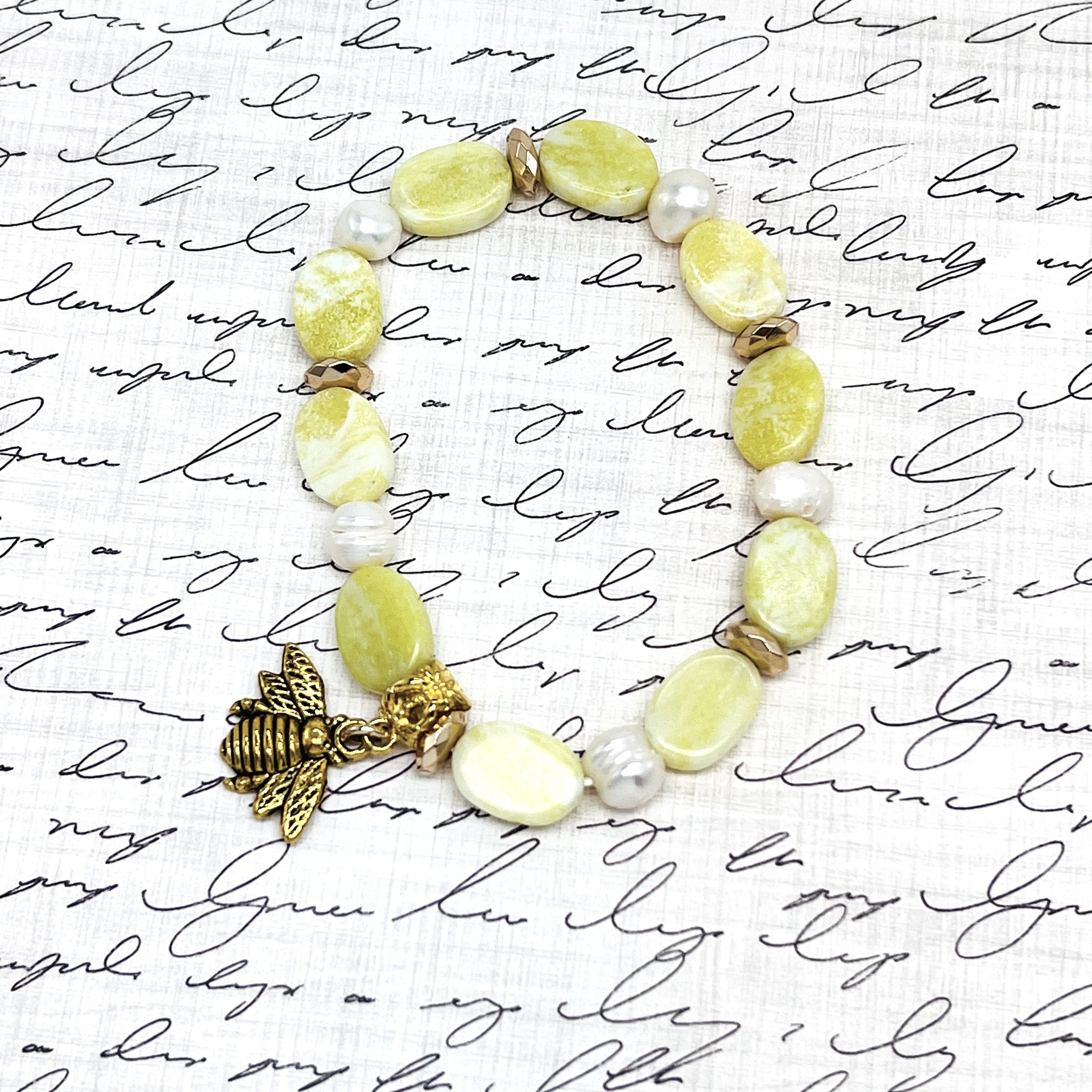 Lovely lemony yellow semiprecious agate stretchy bracelet with pearls and a bee charm with gold hemitite accents