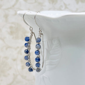 Inspiring blue and gray Sodalite gemstone beads are artistically wire wrapped with silver wire to make lovely earrings