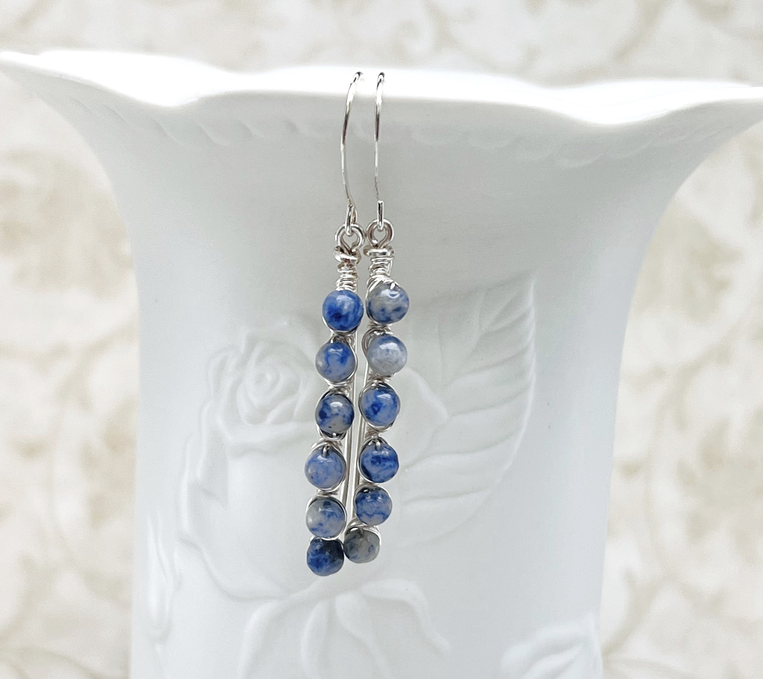 Inspiring blue and gray Sodalite gemstone beads are artistically wire wrapped with silver wire to make lovely earrings