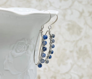 Inspiring blue and gray Sodalite gemstone beads are artistically wire wrapped with silver wire to make lovely earrings