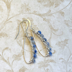 Inspiring blue and gray Sodalite gemstone beads are artistically wire wrapped with silver wire to make lovely earrings