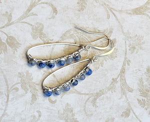 Inspiring blue and gray Sodalite gemstone beads are artistically wire wrapped with silver wire to make lovely earrings