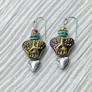 Colorful iridescent glass skulls top a silver heart and are crowned by a sparkling turquoise rhinestone rondel