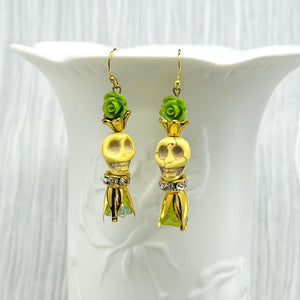 Lovely pale yellow Wagnerite skull earrings with green resin flowers accented in gold