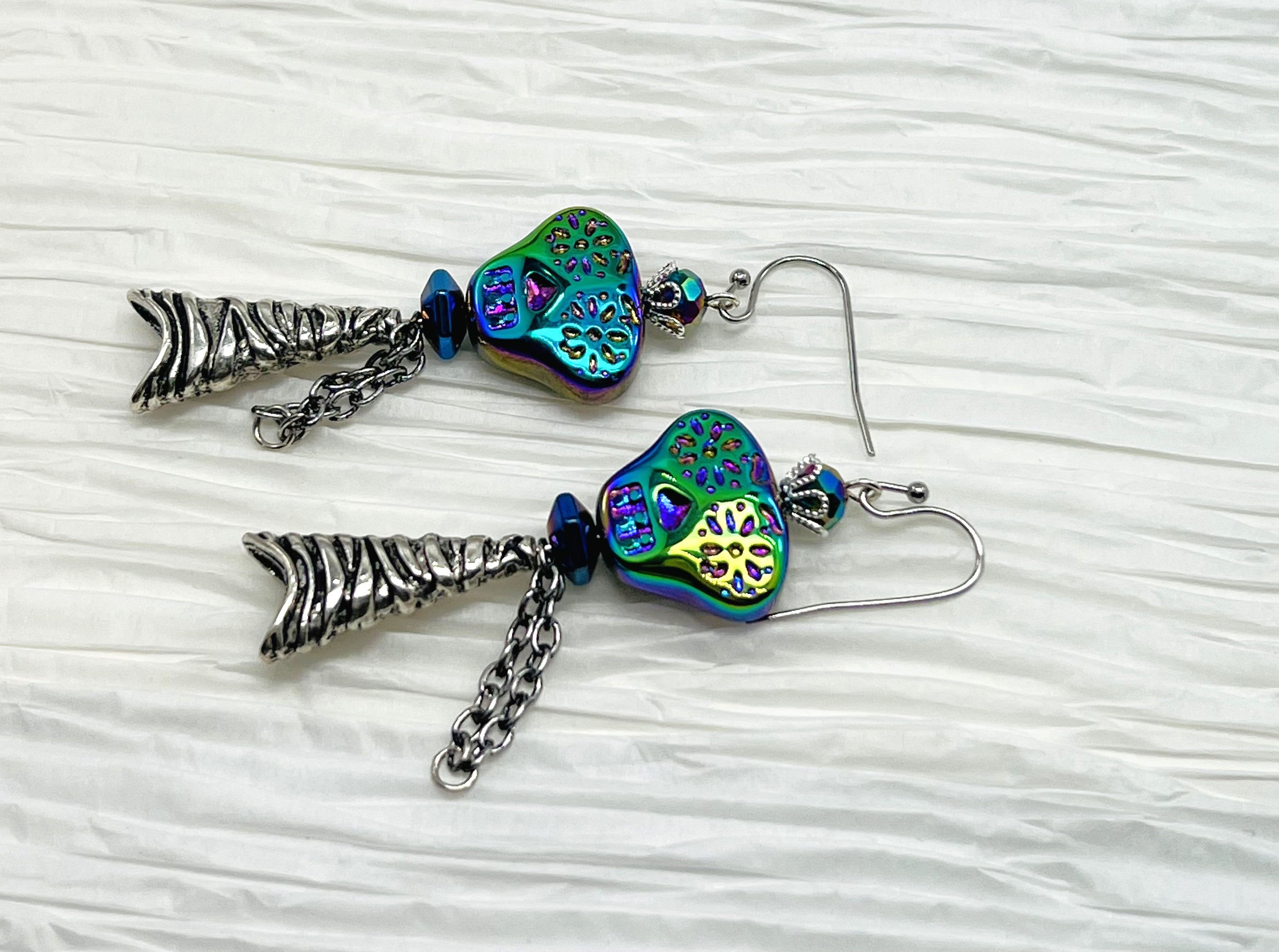 Spooky iridescent glass skull earrings with silver accents