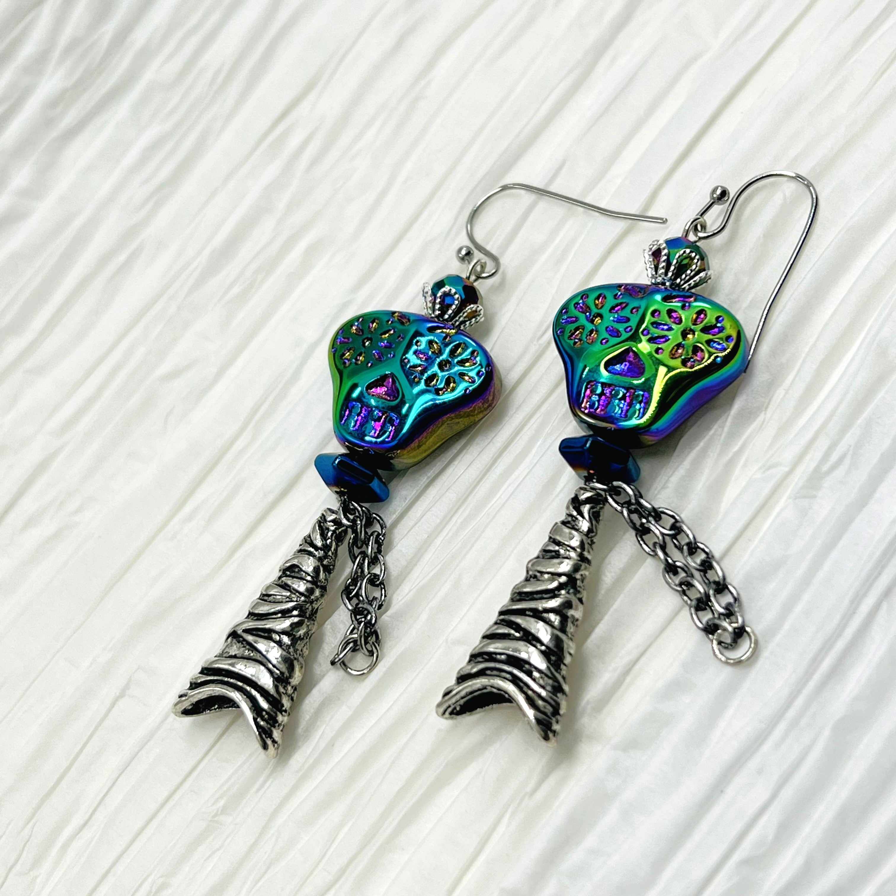 Spooky iridescent glass skull earrings with silver accents