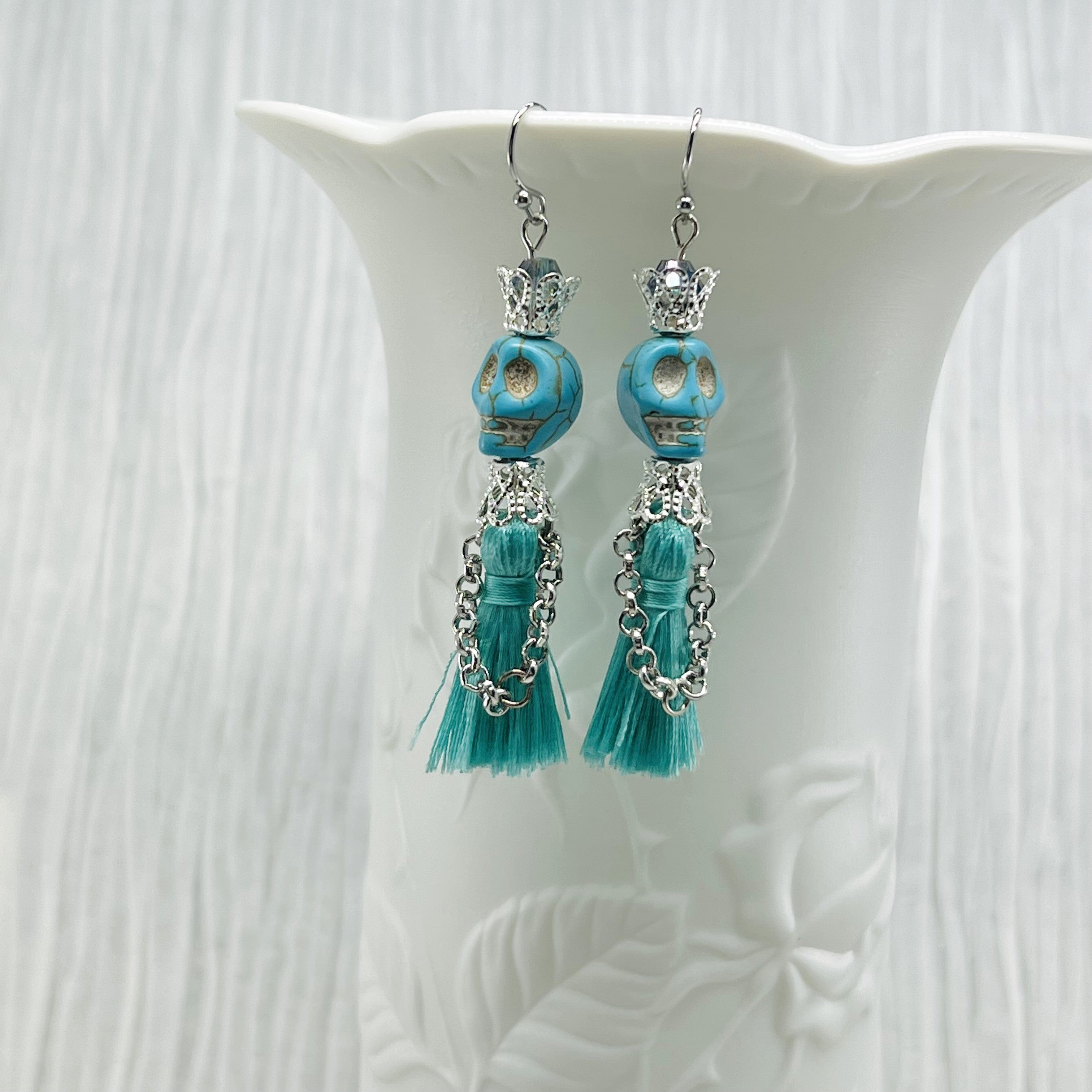 Fancy turquoise Wagnerite skull earrings with a tassel skirt