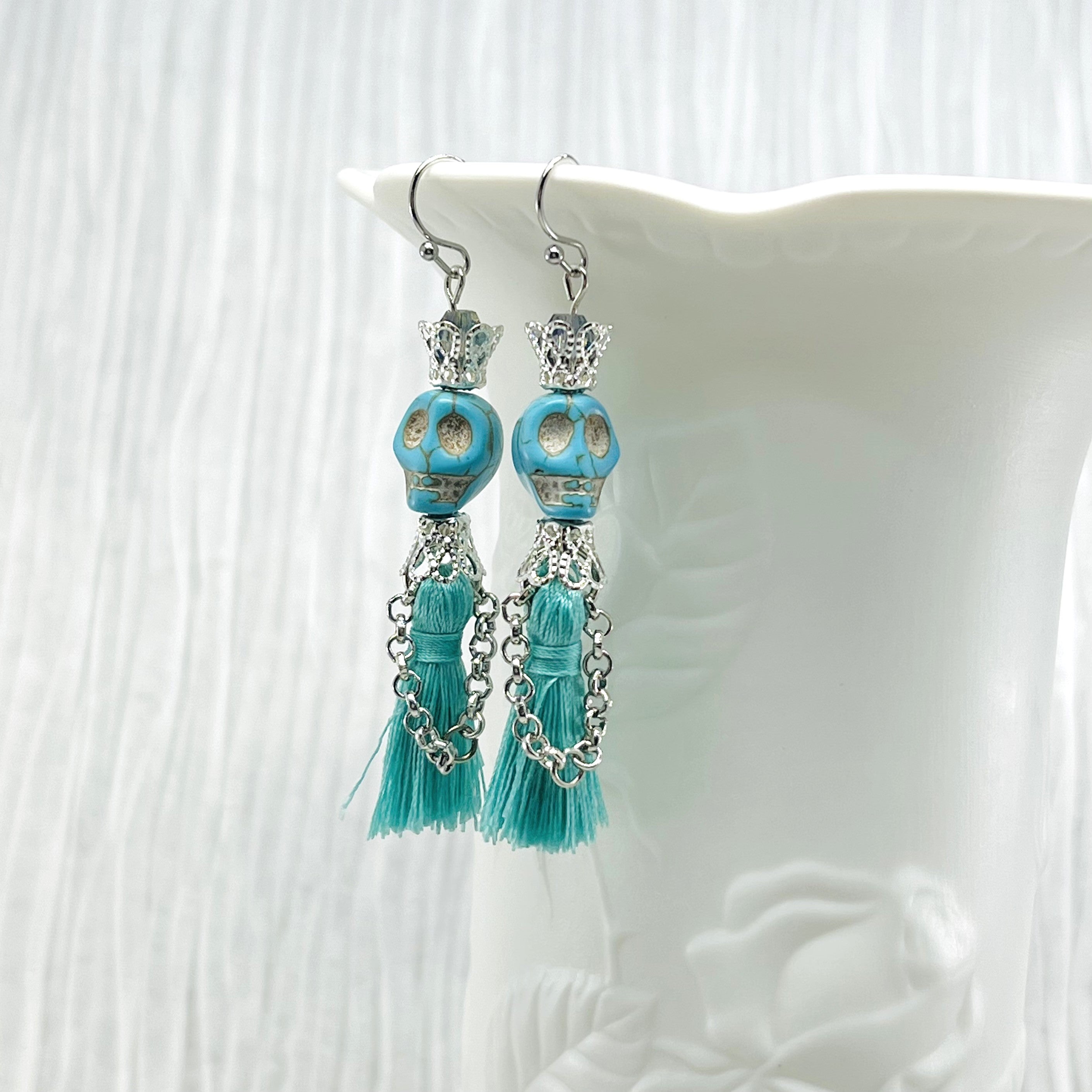 Fancy turquoise Wagnerite skull earrings with a tassel skirt