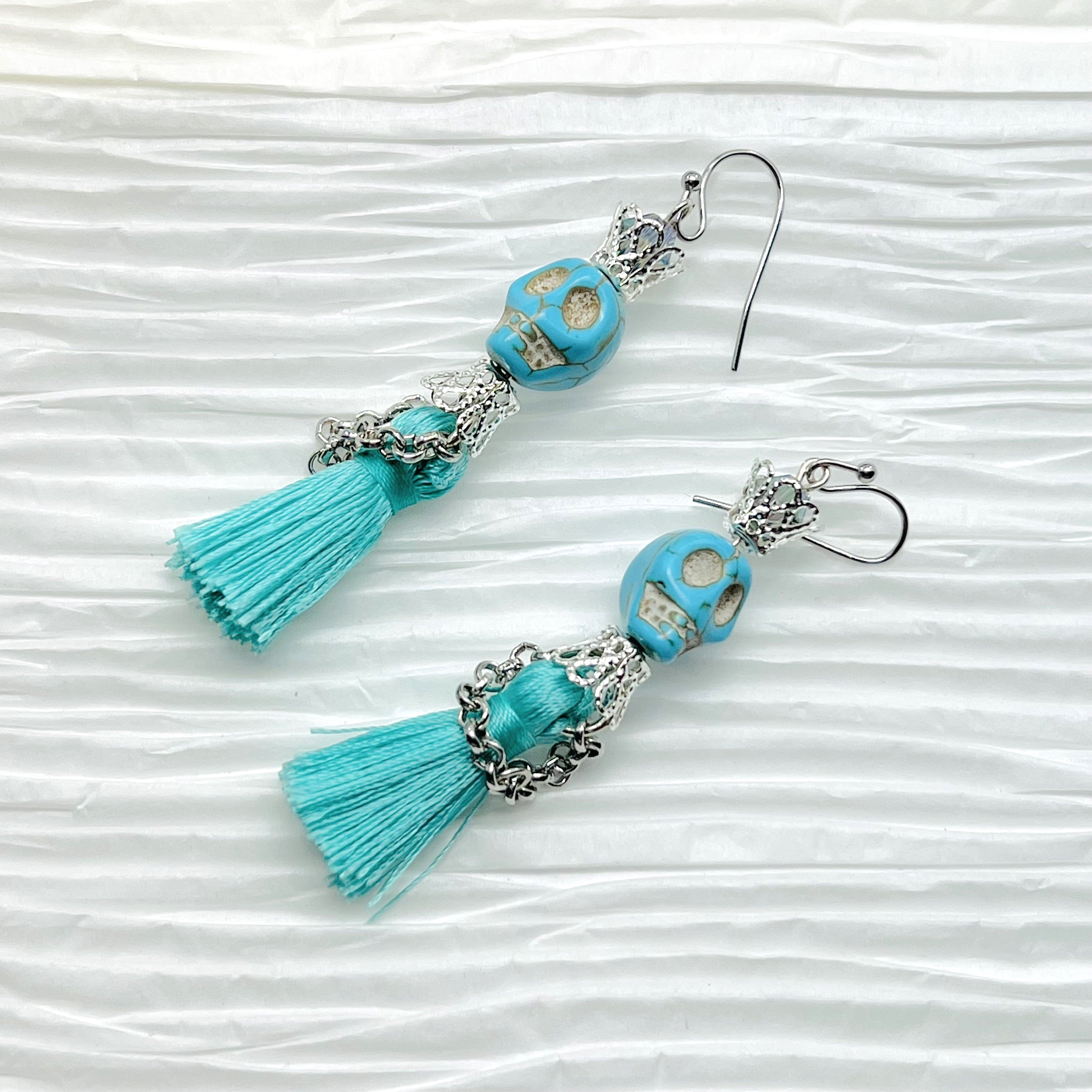 Fancy turquoise Wagnerite skull earrings with a tassel skirt