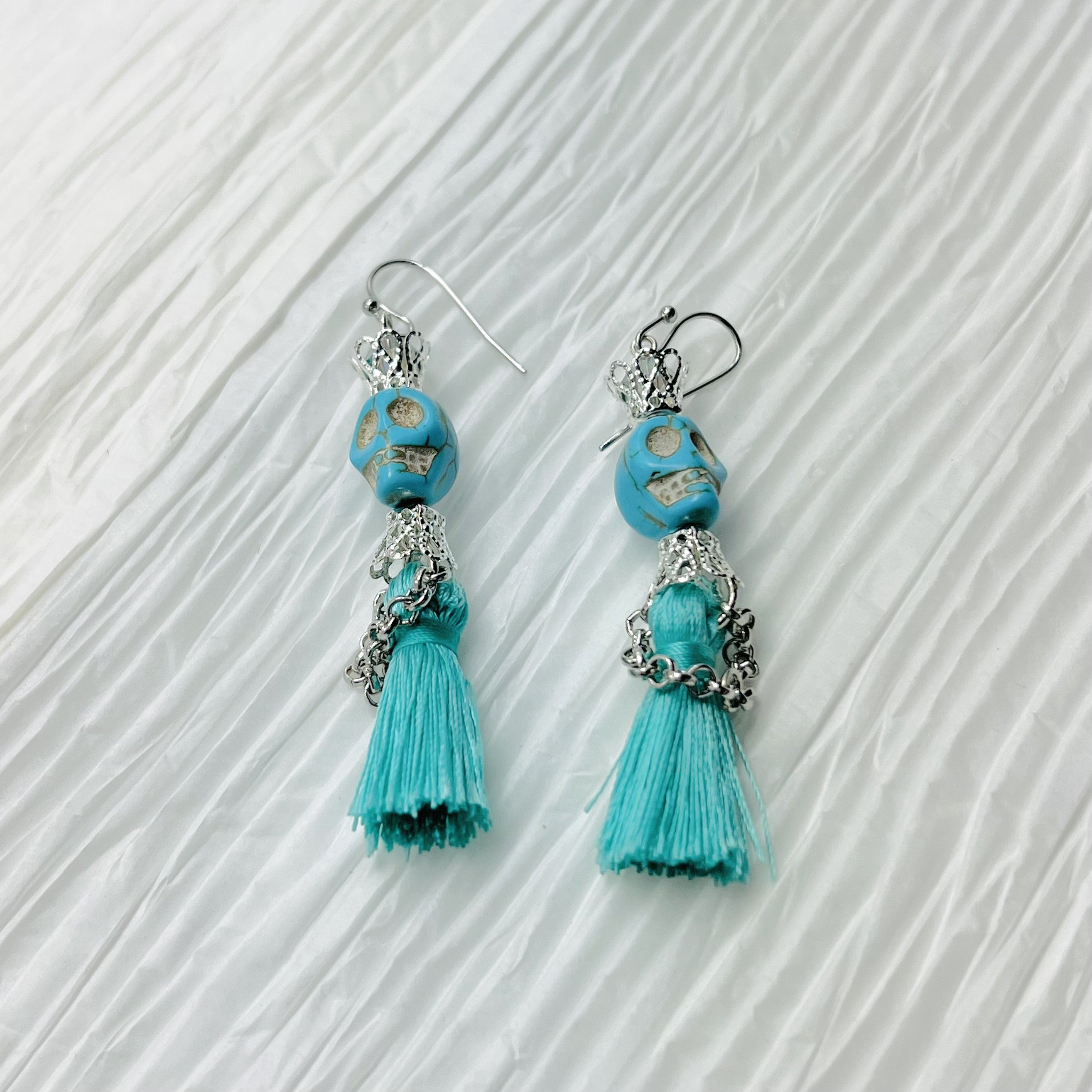 Fancy turquoise Wagnerite skull earrings with a tassel skirt