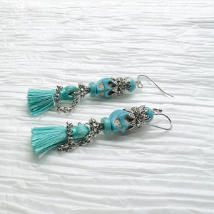 Fancy turquoise Wagnerite skull earrings with sparkling crown and tassel skirt